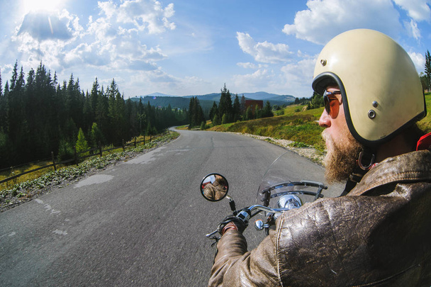 Biker driving his motorcycle on the open road - Photo, Image