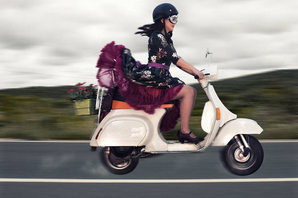 Vintage girl riding a motorcycle - Фото, изображение