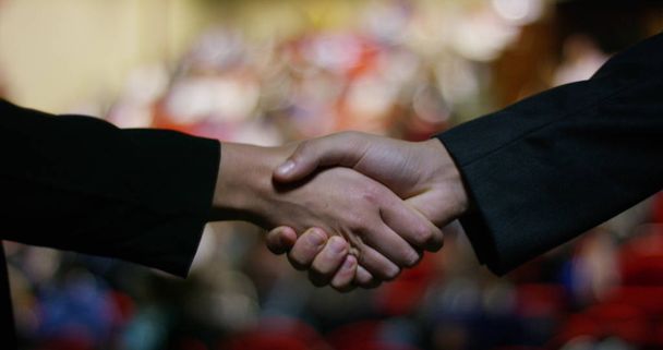 Two businessmen or politicians, elegant clothes, shake hands after finding a deal and successfully concluded the deal work. concept of business, politics, success, economy. - Photo, Image
