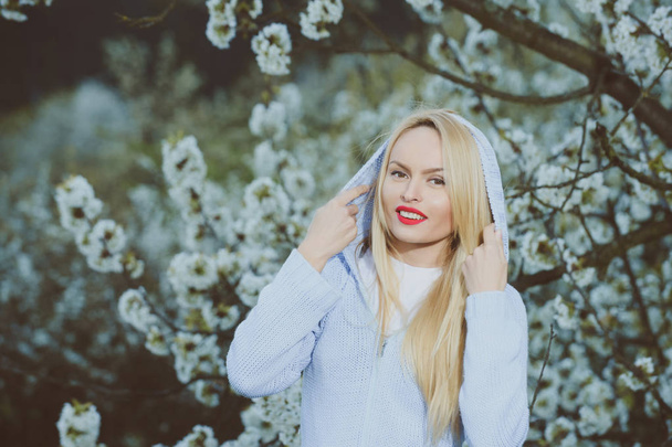 girl with red lips and blonde hair in blossom - Fotó, kép