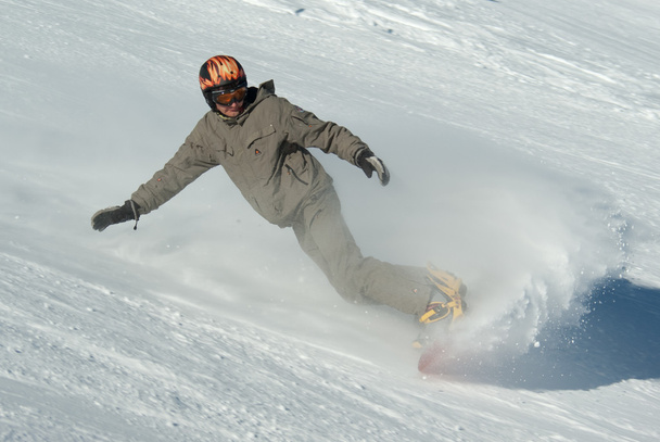 Snowboarder riding down the hill - Photo, Image