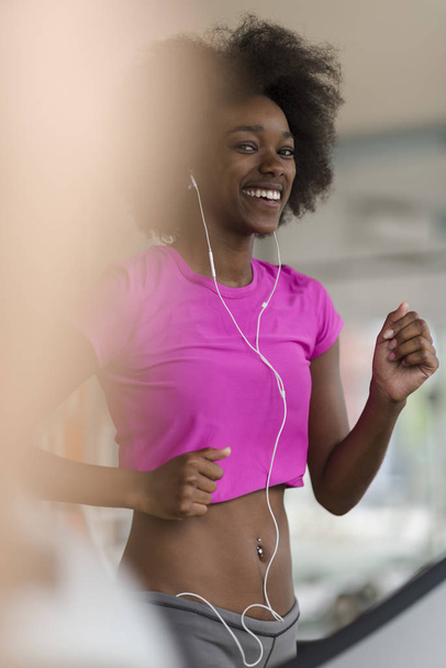 afro american woman running on a treadmill - Foto, Imagem