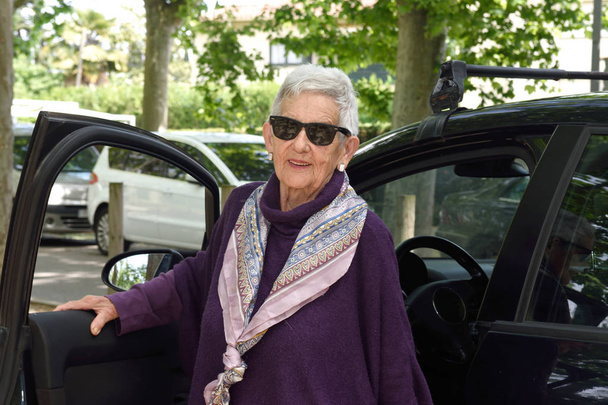 portrait of senior woman with car - Fotó, kép