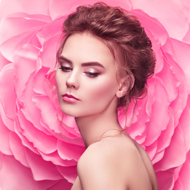 Beautiful woman on the background of a large flower - Photo, Image
