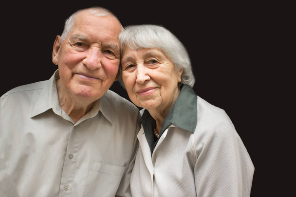 The happy elderly couple on the black background - Photo, Image