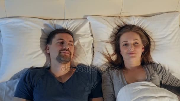 Two happy satisfied people lying in the bed. Happy sex life concept. 4K. - Materiał filmowy, wideo