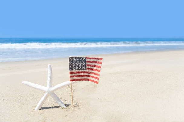Patriotic USA background with starfish on the sandy beach - Photo, Image