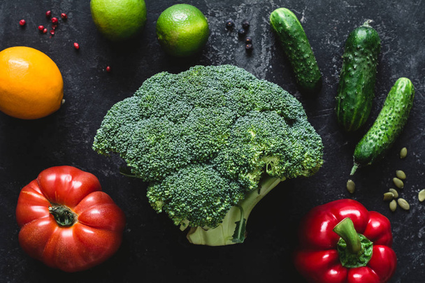 Broccoli head and vegetables on dark background - Foto, immagini
