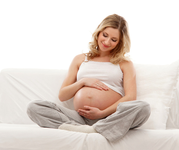 Young attractive pregnant woman on the sofa - Foto, Imagen