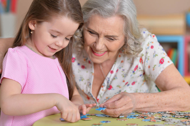 Grandmother collecting puzzle - Fotó, kép