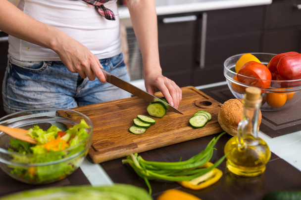 Woman preparing salad in the kitchen  - Photo, Image