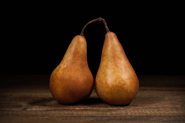 Food. Juicy pears conference on a dark wooden table - Foto, afbeelding