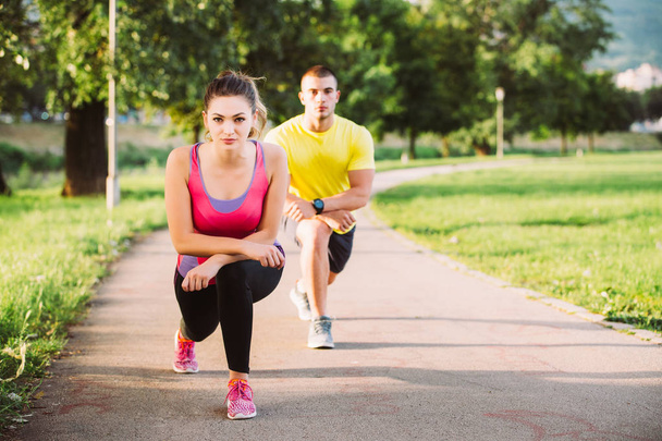 Couple stretching before jogging - Фото, зображення