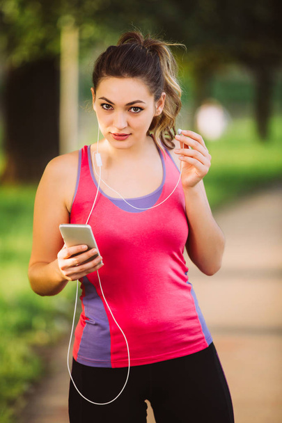Young lady jogging in a park  - Zdjęcie, obraz