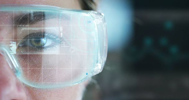A woman watches with a futuristic look with glasses. augmented reality in holography. - Photo, Image