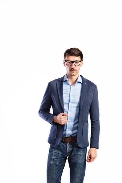 Handsome young man in blue jacket. Studio shot, isolated. - Photo, image