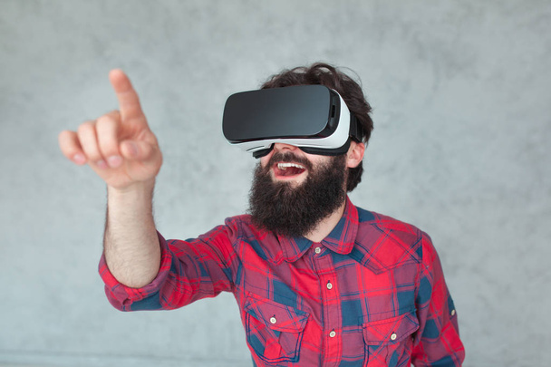 Cheerful man touching air in VR goggles - Fotoğraf, Görsel