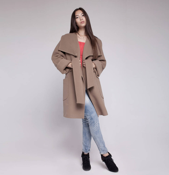 fashion asian model in autumn/winter clothes posing in light background - Foto, Imagem