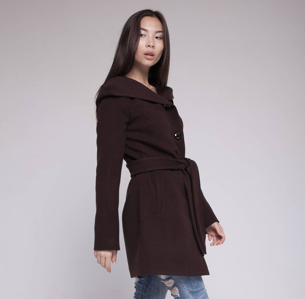 fashion asian model in autumn/winter clothes posing in light background - Valokuva, kuva