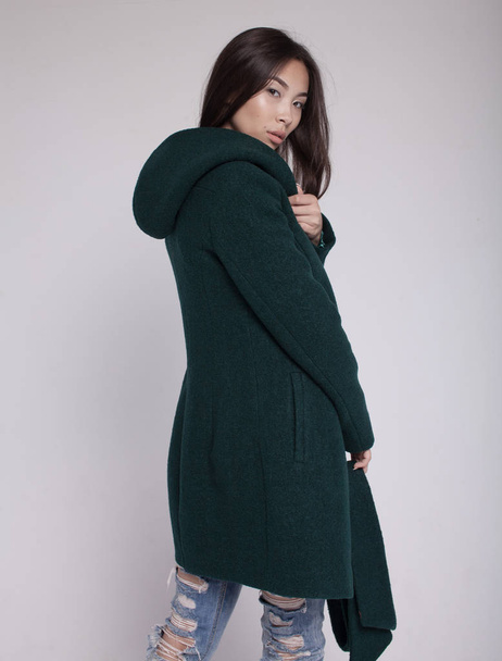 fashion asian model in autumn/winter clothes posing in light background - Foto, immagini
