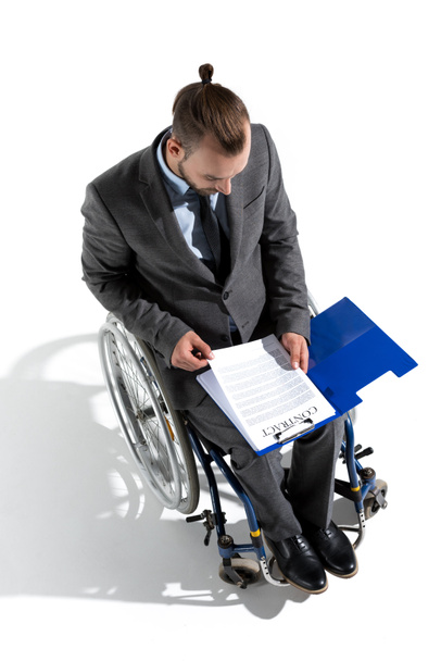 businessman in wheelchair looking at contract - Photo, Image