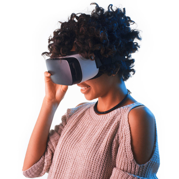 Cheerful woman adjusting the VR goggles - Foto, imagen