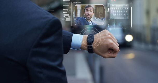A businessman call a friend and colleague who appears in hologram clock futuristic and technological. - Fotoğraf, Görsel