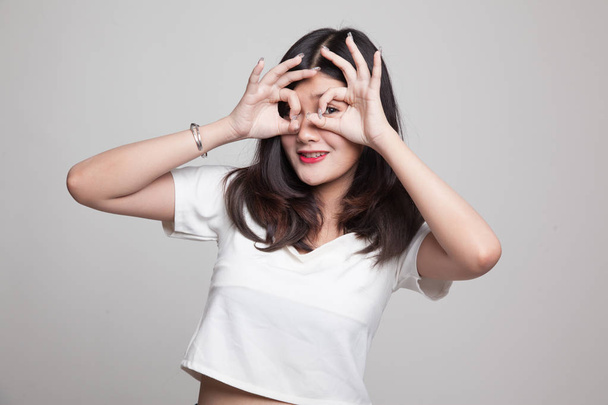 Asian woman do funny  double OK sign as glasses. - Foto, immagini