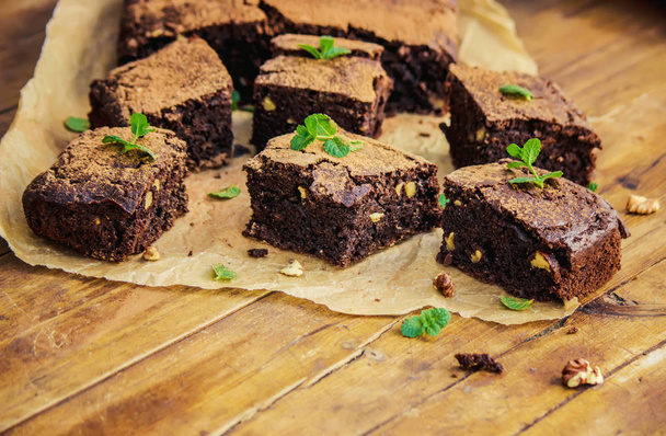 Chocolate walnut brownie with sprigs of mint. Selective focus. - Photo, Image