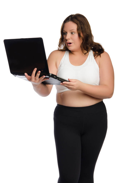 surprised fat sporty woman with laptop - Foto, afbeelding
