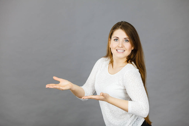 Happy woman presenting copyspace with hands - Φωτογραφία, εικόνα