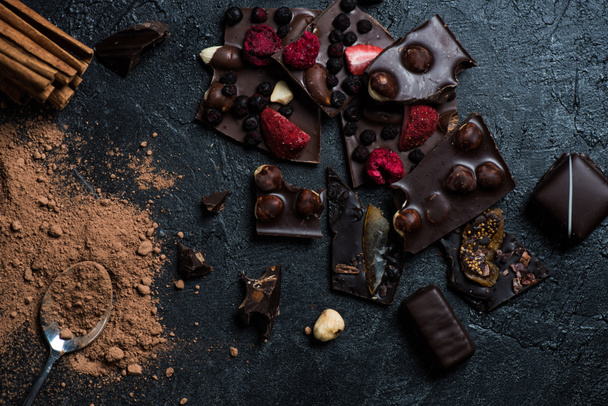 pieces of chocolate with nuts and berries with cinnamon - Photo, Image