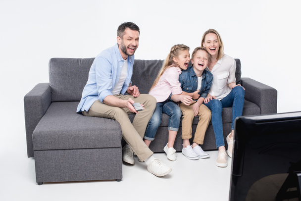 family sitting on sofa and watching tv - Foto, Imagem