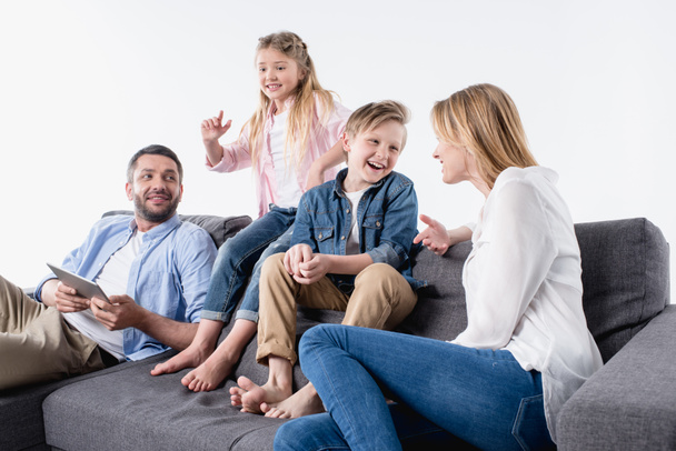caucasian family sitting on sofa together - Foto, imagen