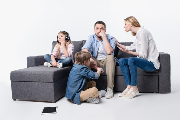 caucasian family sitting on sofa together - Fotó, kép