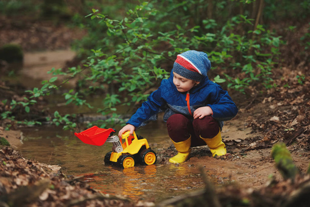 little boy playing with toy truck - Fotó, kép