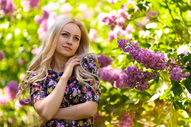 Beautiful woman portrait in lilac tree flowers - Fotoğraf, Görsel