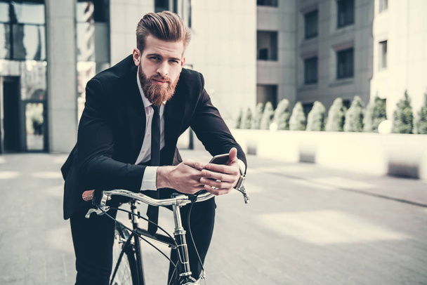 Businessman with bicycle - Fotoğraf, Görsel