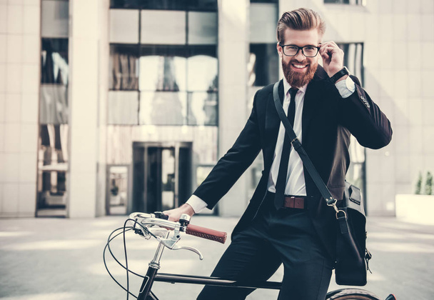 Businessman with bicycle - Фото, изображение