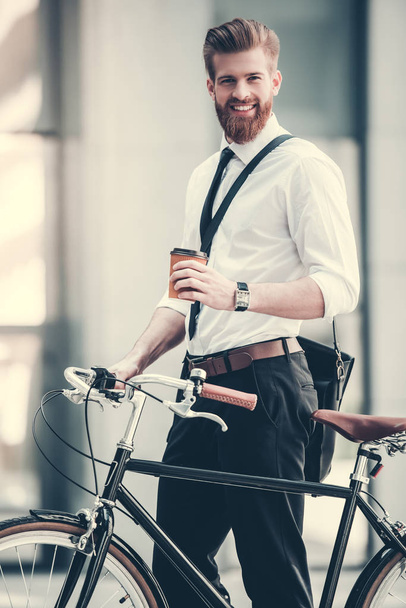 Businessman with bicycle - Фото, изображение