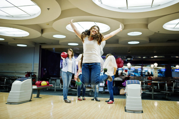 Group of girls having fun and play bowling at hen party. - Foto, afbeelding