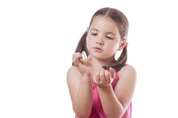 Young girl holding an open fortune cookie - Photo, Image