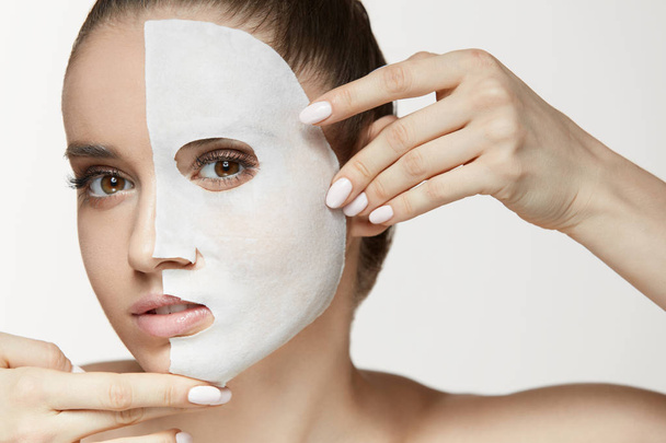 Female Beauty Face Skin Treatment. Woman With White Sheet Mask - 写真・画像