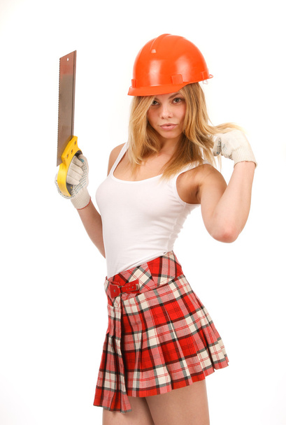 Beauty in the orange helmet and a saw on a white background. - Zdjęcie, obraz