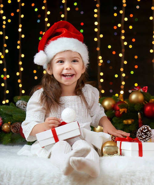 child girl portrait in christmas decoration, happy emotions, winter holiday concept, dark background with illumination and boke lights - Fotoğraf, Görsel