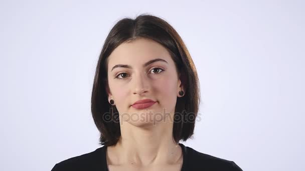 Sad young female sighing with disappointment standing on white background - Video, Çekim