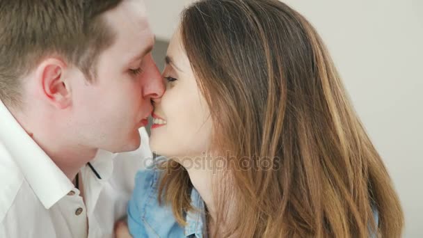 man and a woman in love look at each other and kiss each other gently - Video