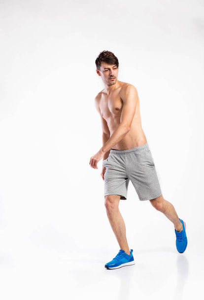 Shirtless fitness man in gray shorts. Studio shot. - Fotoğraf, Görsel