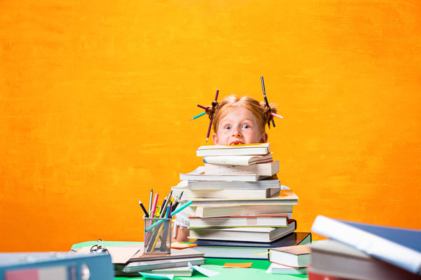The Redhead teen girl with lot of books at home. Studio shot - Valokuva, kuva