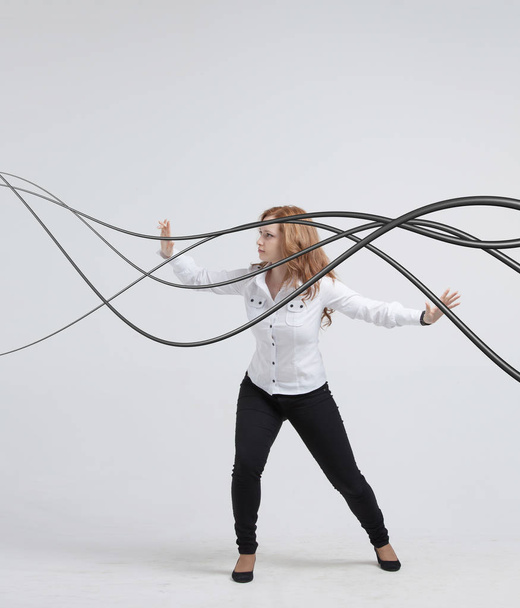 Woman with electrical cables or wires, curved lines. - Φωτογραφία, εικόνα
